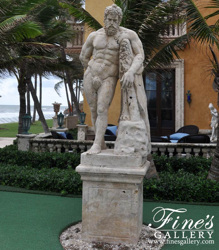 A carved statue of Hercules in light travertine